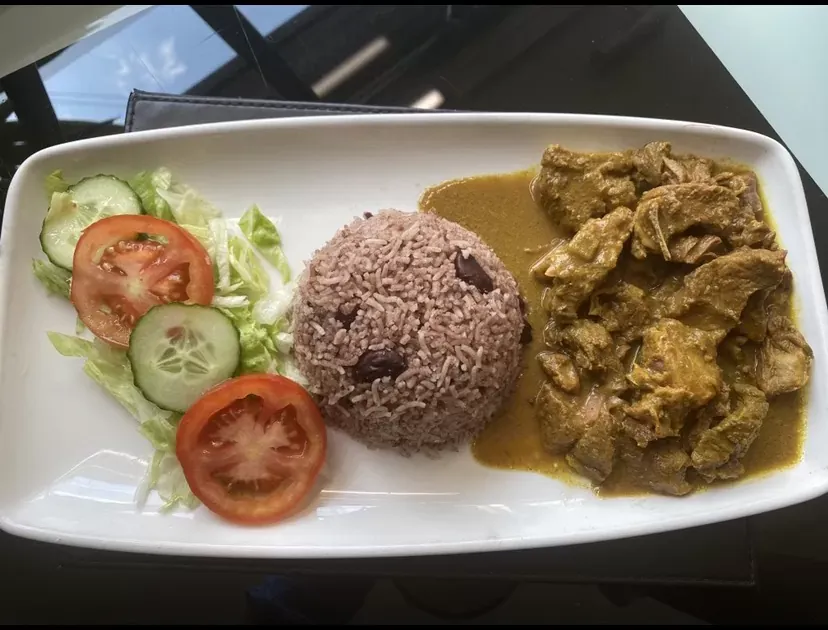 Curry goat with rice and peas and fresh salad Jemz Caribbean Café Bedford