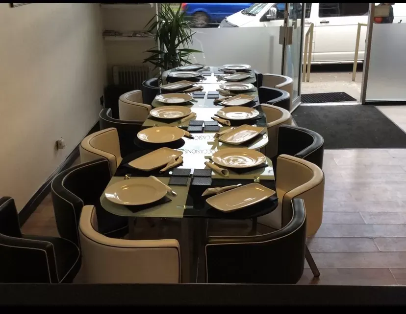Dining room set up with a long table for a private event at Jemz Caribbean Café Bedford