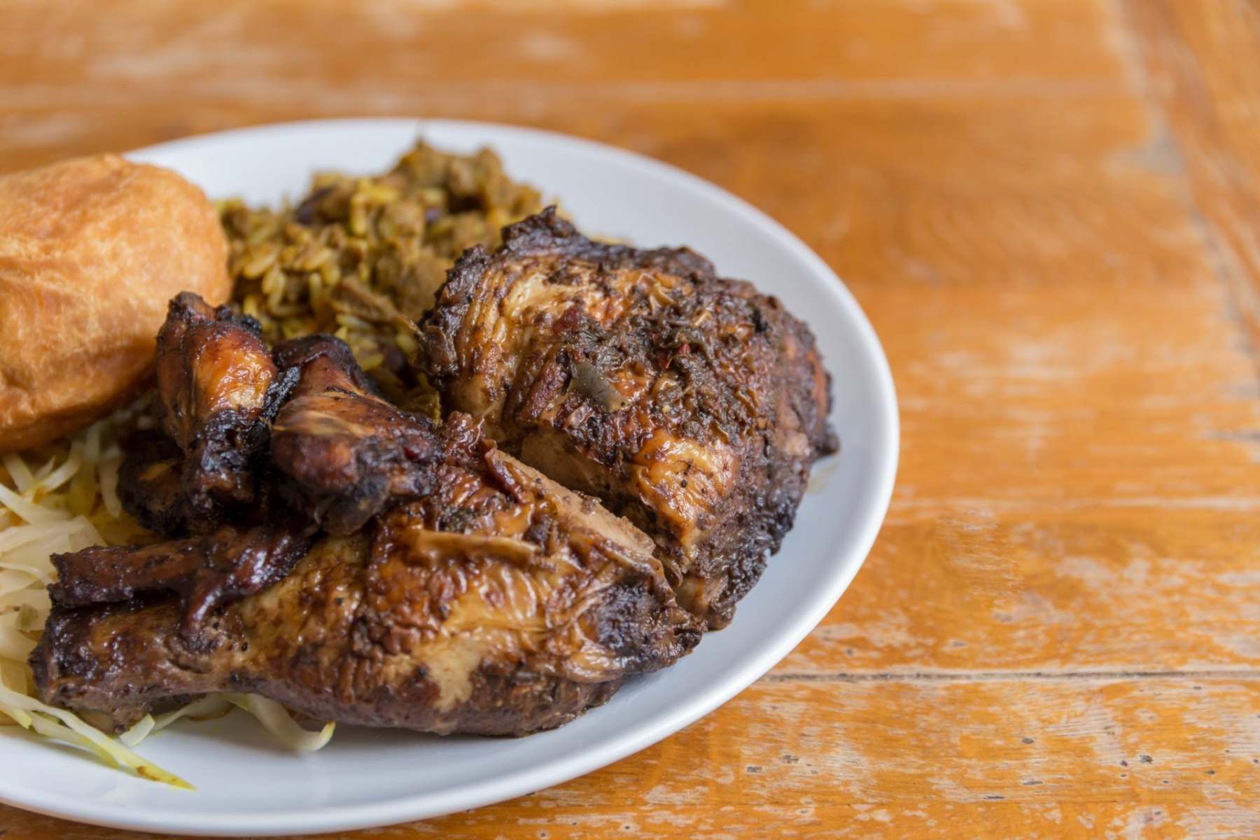 Jerk chicken with curry goat and fried dumpling Jemz Caribbean Café Bedford